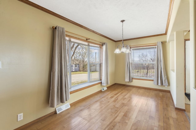 323 Shadrack Rd, Cape Fair, MO 65624 - unfurnished dining area featuring a chandelier, ornamental molding, healthy amount of natural light, a textured ceiling, and baseboards