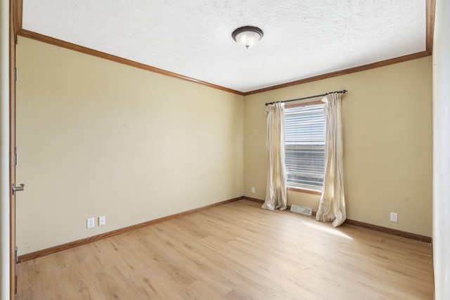 323 Shadrack Rd, Cape Fair, MO 65624 - spare room featuring crown molding, light wood-style flooring, baseboards, and a textured ceiling