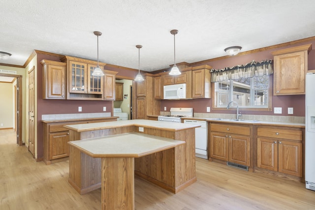 323 Shadrack Rd, Cape Fair, MO 65624 - kitchen with white appliances, a sink, a kitchen island, washer / dryer, and light wood-type flooring