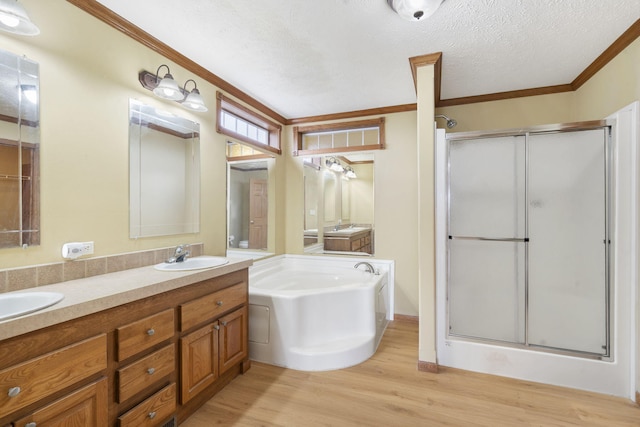 323 Shadrack Rd, Cape Fair, MO 65624 - full bath featuring ornamental molding, a shower stall, wood finished floors, double vanity, and a garden tub
