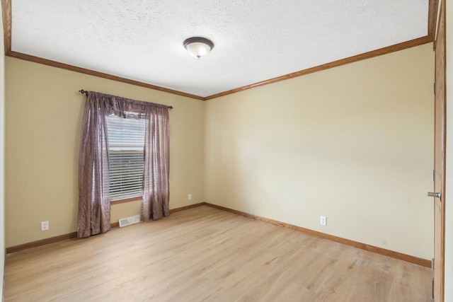 323 Shadrack Rd, Cape Fair, MO 65624 - spare room featuring light wood-type flooring, crown molding, baseboards, and a textured ceiling