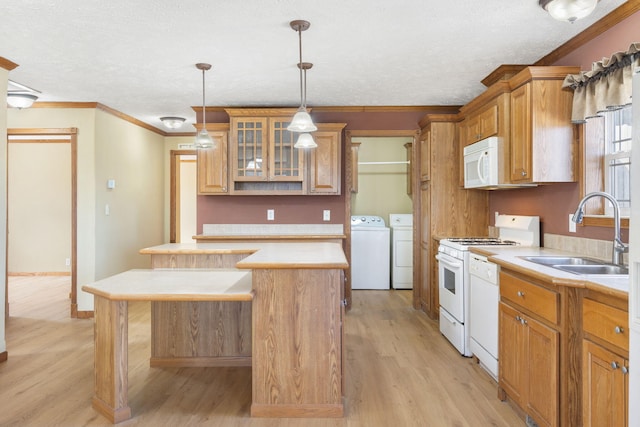323 Shadrack Rd, Cape Fair, MO 65624 - kitchen with a sink, washer and clothes dryer, white appliances, a kitchen island, and ornamental molding