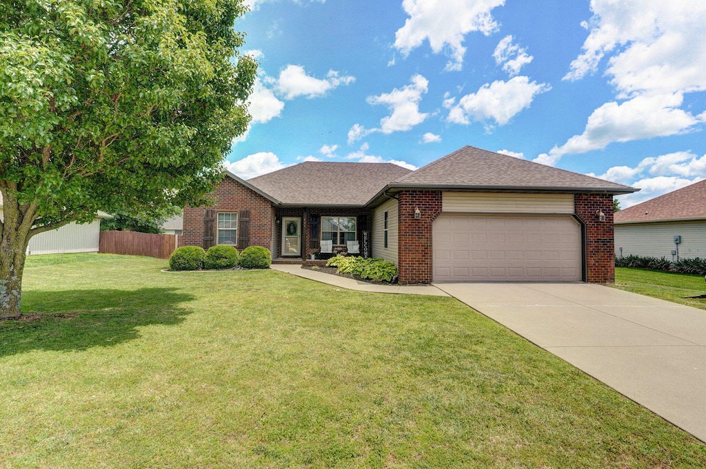 754 N Lexington Ave, Republic, MO 65738 - ranch-style home featuring brick siding, a garage, driveway, and roof with shingles