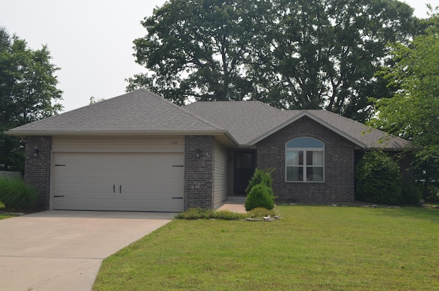 532 Holiday St, Highlandville, MO 65669 - single story home featuring brick siding, a garage, concrete driveway, a front yard, and roof with shingles