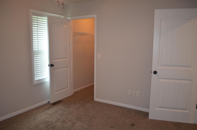 532 Holiday St, Highlandville, MO 65669 - unfurnished bedroom with carpet floors, a spacious closet, baseboards, and a closet