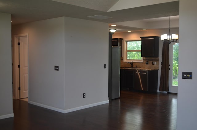 532 Holiday St, Highlandville, MO 65669 - kitchen featuring appliances with stainless steel finishes, a chandelier, dark wood-style floors, backsplash, and a sink