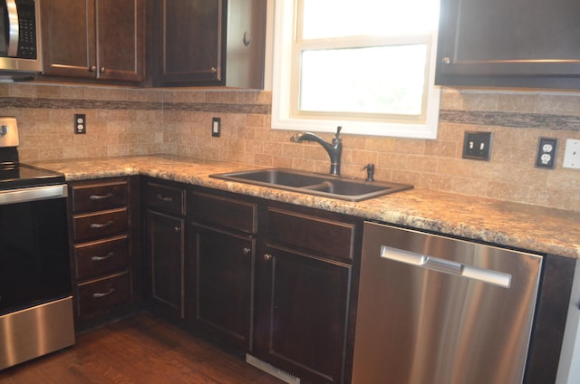 532 Holiday St, Highlandville, MO 65669 - kitchen featuring stainless steel appliances, a sink, backsplash, and dark brown cabinetry