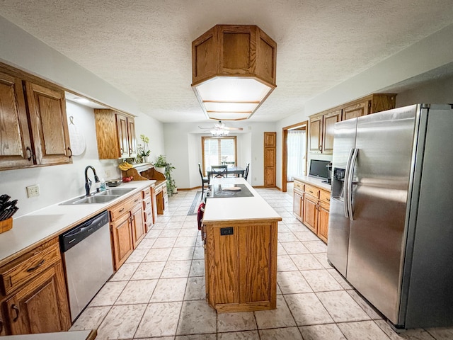 5350 E Farm Road 168, Rogersville, MO 65742 - kitchen with appliances with stainless steel finishes, a sink, a center island, a textured ceiling, and light countertops