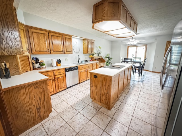 5350 E Farm Road 168, Rogersville, MO 65742 - kitchen with appliances with stainless steel finishes, a center island, a sink, light countertops, and a textured ceiling