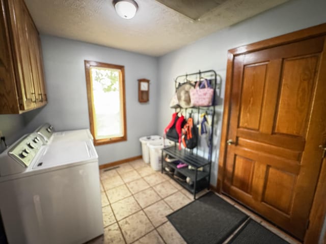 5350 E Farm Road 168, Rogersville, MO 65742 - laundry room with cabinet space, separate washer and dryer, a textured ceiling, baseboards, and light tile patterned flooring