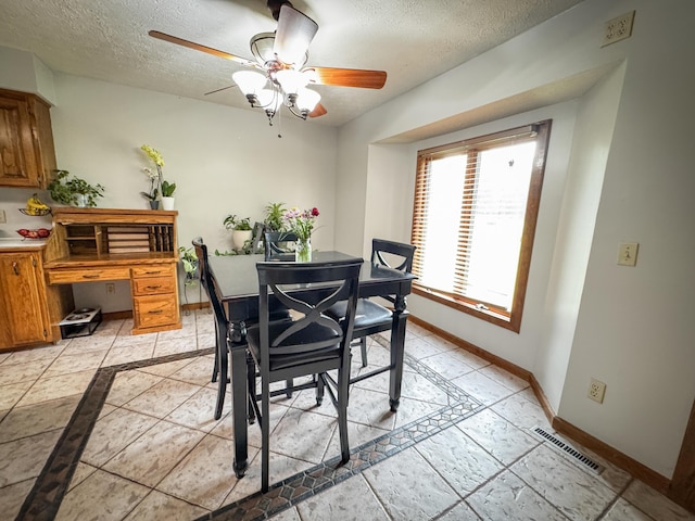 5350 E Farm Road 168, Rogersville, MO 65742 - dining room with baseboards, ceiling fan, and a textured ceiling