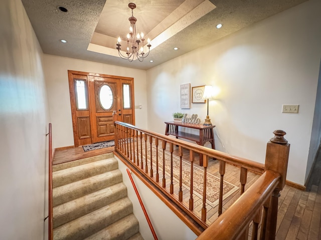 5350 E Farm Road 168, Rogersville, MO 65742 - stairway featuring wood-type flooring, a tray ceiling, a chandelier, recessed lighting, and baseboards