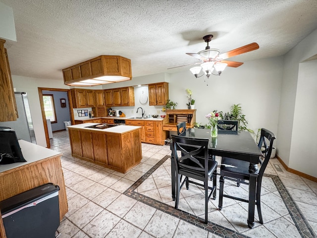 5350 E Farm Road 168, Rogersville, MO 65742 - kitchen with brown cabinets, inlaid floor details, light countertops, a sink, and a center island