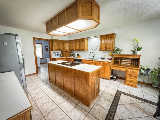 5350 E Farm Road 168, Rogersville, MO 65742 - kitchen featuring a sink, brown cabinets, light countertops, stainless steel appliances, and a center island