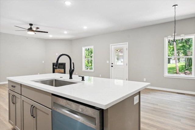 1239 W Arlington Ct, Springfield, MO 65803 - kitchen featuring dishwasher, a sink, ceiling fan, a kitchen island with sink, and light countertops