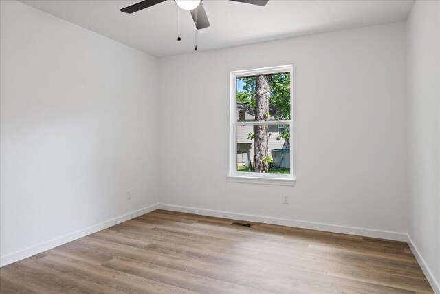 1239 W Arlington Ct, Springfield, MO 65803 - empty room featuring wood finished floors, ceiling fan, and baseboards