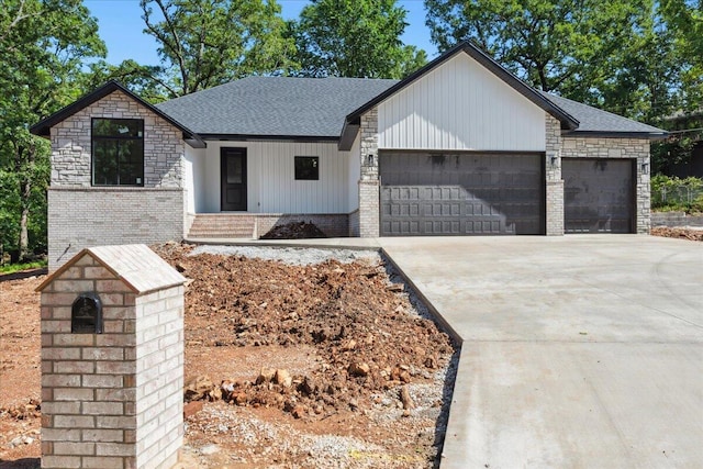 1239 W Arlington Ct, Springfield, MO 65803 - view of front of property featuring an attached garage, concrete driveway, roof with shingles, and brick siding