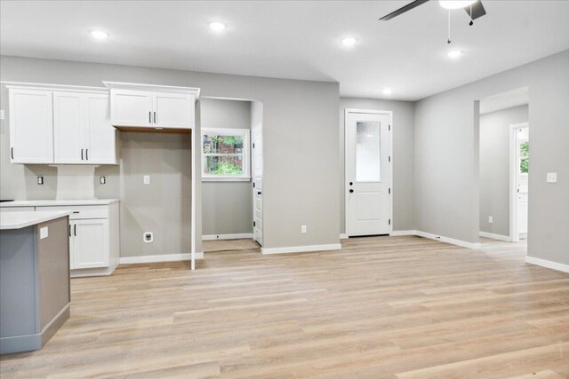 1239 W Arlington Ct, Springfield, MO 65803 - kitchen featuring ceiling fan, light countertops, white cabinetry, baseboards, and recessed lighting