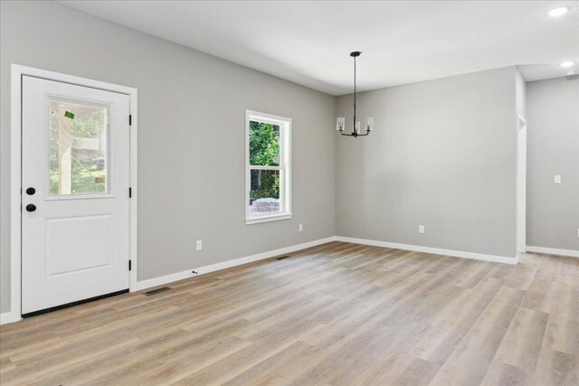 1239 W Arlington Ct, Springfield, MO 65803 - unfurnished dining area with plenty of natural light, a chandelier, light wood finished floors, and recessed lighting