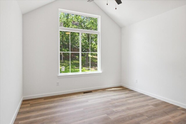 1239 W Arlington Ct, Springfield, MO 65803 - empty room featuring plenty of natural light, a ceiling fan, light wood-type flooring, lofted ceiling, and baseboards