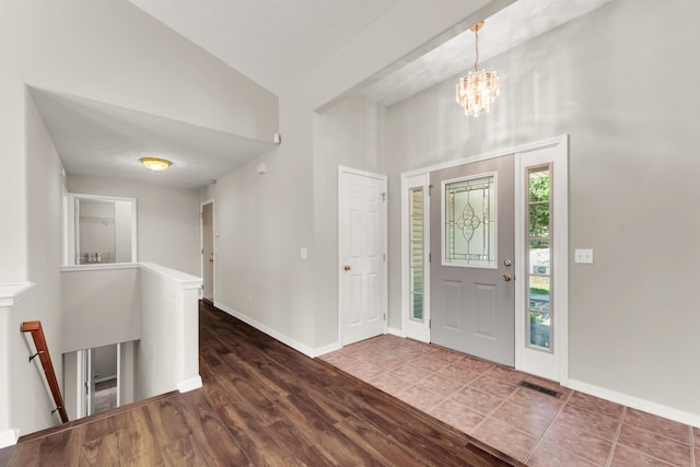 315 Rock Ridge Rd, Branson West, MO 65737 - foyer entrance featuring a chandelier, baseboards, a high ceiling, and wood finished floors
