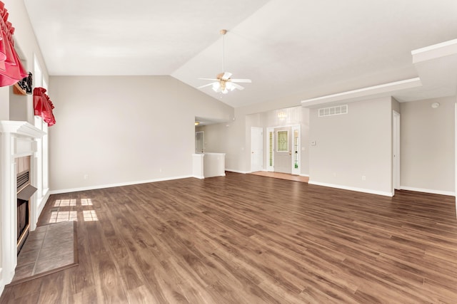 315 Rock Ridge Rd, Branson West, MO 65737 - unfurnished living room featuring a ceiling fan, a tiled fireplace, wood finished floors, vaulted ceiling, and baseboards