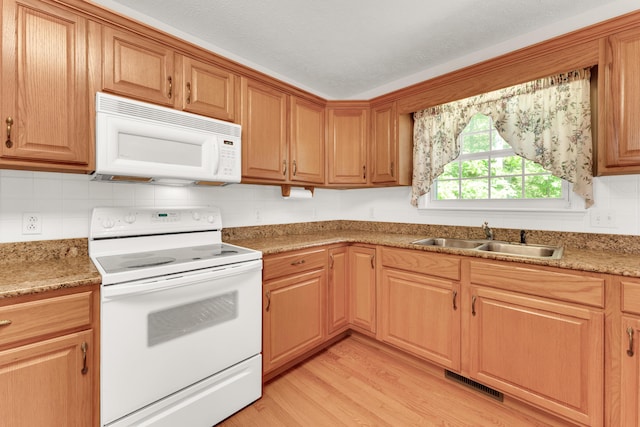 315 Rock Ridge Rd, Branson West, MO 65737 - kitchen featuring white appliances, a sink, light wood-style flooring, decorative backsplash, and light countertops