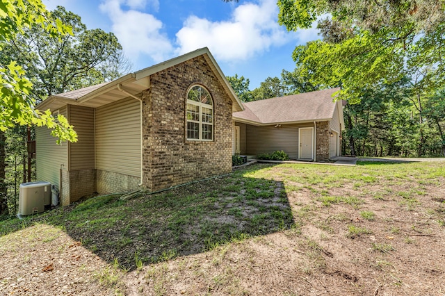 315 Rock Ridge Rd, Branson West, MO 65737 - view of property exterior featuring brick siding, cooling unit, and a garage