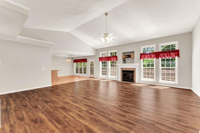 315 Rock Ridge Rd, Branson West, MO 65737 - unfurnished living room featuring a tile fireplace, a ceiling fan, plenty of natural light, wood finished floors, and lofted ceiling