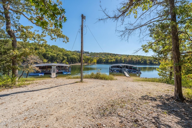 315 Rock Ridge Rd, Branson West, MO 65737 - water view featuring a floating dock and a heavily wooded area