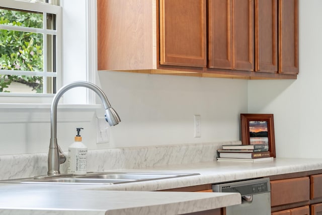 343 Cedar Glade Dr, Branson West, MO 65737 - kitchen view of a sink, dishwasher, light countertops, and brown cabinetry