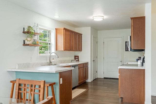 343 Cedar Glade Dr, Branson West, MO 65737 - kitchen with a sink, stainless steel appliances, dark wood-style floors, a peninsula, and a breakfast bar area