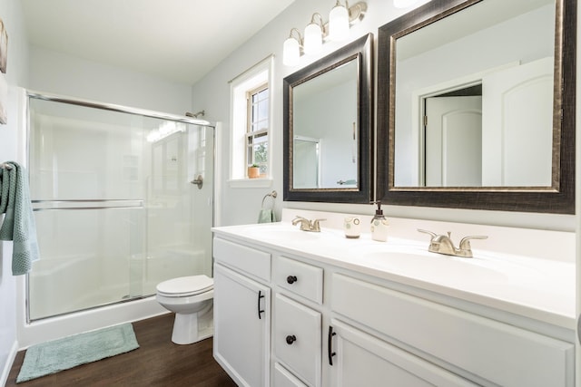 343 Cedar Glade Dr, Branson West, MO 65737 - bathroom featuring a stall shower, wood finished floors, double vanity, and toilet
