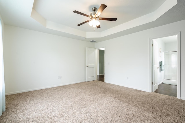 343 Cedar Glade Dr, Branson West, MO 65737 - unfurnished bedroom with a tray ceiling, carpet, baseboards, and ensuite bath