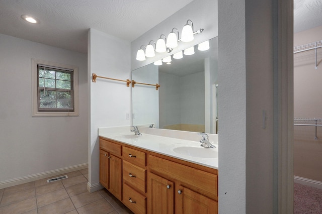 2304 S 12th St, Ozark, MO 65721 - full bath featuring double vanity, a spacious closet, tile patterned floors, and baseboards