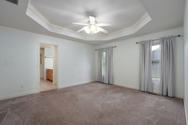 2304 S 12th St, Ozark, MO 65721 - empty room featuring a tray ceiling, ceiling fan, carpet flooring, baseboards, and ornamental molding