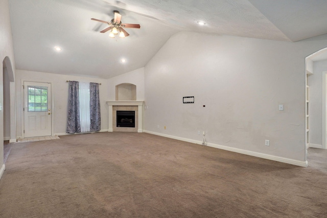 2304 S 12th St, Ozark, MO 65721 - unfurnished living room with vaulted ceiling, a ceiling fan, arched walkways, a fireplace, and baseboards