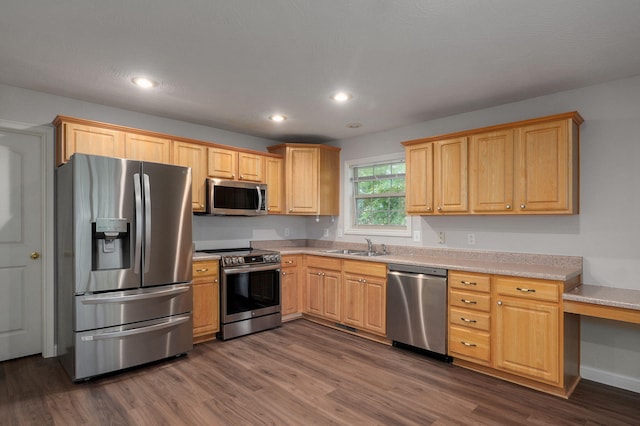 2304 S 12th St, Ozark, MO 65721 - kitchen with appliances with stainless steel finishes, dark wood-type flooring, light countertops, recessed lighting, and a sink