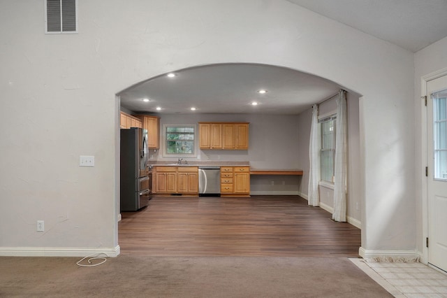 2304 S 12th St, Ozark, MO 65721 - kitchen with appliances with stainless steel finishes, arched walkways, a sink, baseboards, and recessed lighting