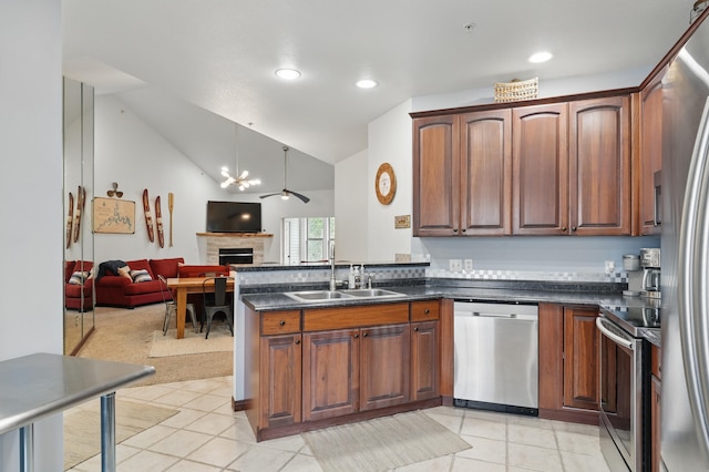 235 Lower Emerald Bay Cir Unit C-6, Hollister, MO 65672 - kitchen featuring appliances with stainless steel finishes, a sink, open floor plan, a peninsula, and light tile patterned flooring