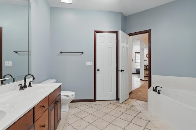 235 Lower Emerald Bay Cir Unit C-6, Hollister, MO 65672 - bathroom with double vanity, a bath, toilet, tile patterned floors, and baseboards