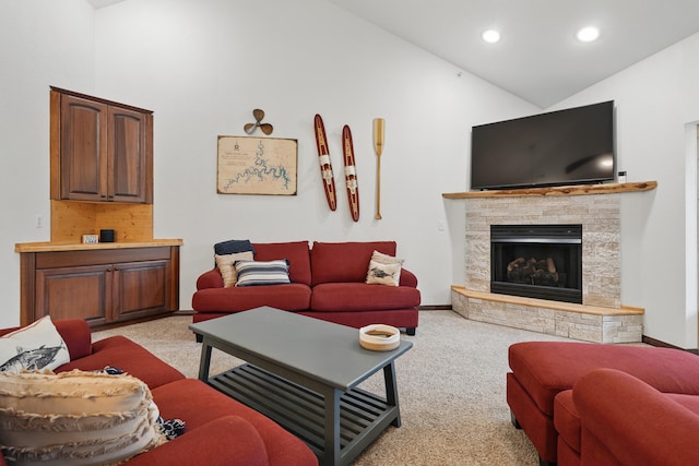 235 Lower Emerald Bay Cir Unit C-6, Hollister, MO 65672 - living area with light colored carpet, recessed lighting, a stone fireplace, high vaulted ceiling, and baseboards