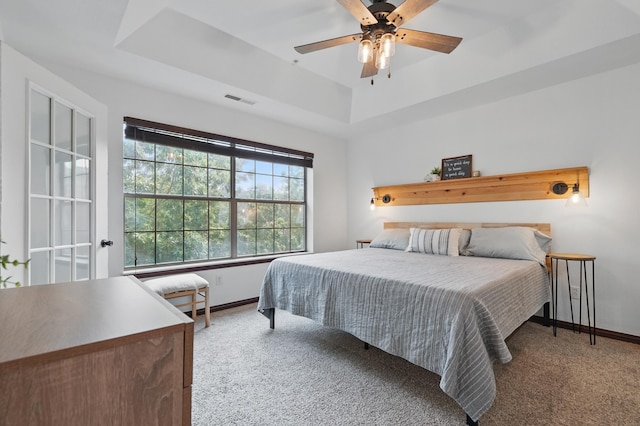 235 Lower Emerald Bay Cir Unit C-6, Hollister, MO 65672 - carpeted bedroom featuring a tray ceiling, baseboards, and ceiling fan