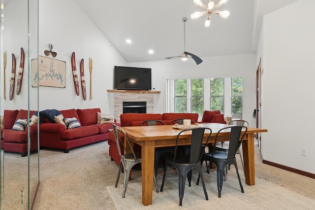 235 Lower Emerald Bay Cir Unit C-6, Hollister, MO 65672 - dining area with a fireplace, light carpet, high vaulted ceiling, baseboards, and a chandelier