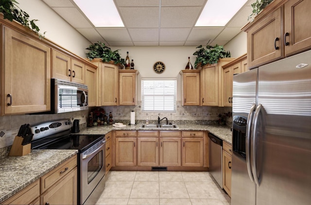 235 Lower Emerald Bay Cir Unit C-6, Hollister, MO 65672 - kitchen with appliances with stainless steel finishes, a sink, a paneled ceiling, tasteful backsplash, and light tile patterned flooring