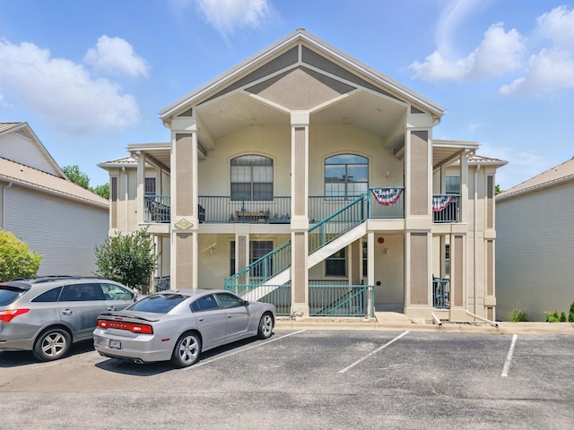 235 Lower Emerald Bay Cir Unit C-6, Hollister, MO 65672 - view of property with uncovered parking and stairs