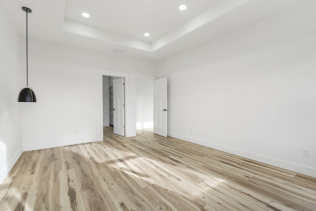 2048 N Sun Valley Dr, Springfield, MO 65802 - unfurnished bedroom with light wood-type flooring, recessed lighting, baseboards, and a raised ceiling