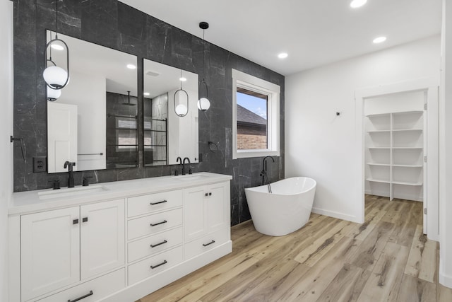 2048 N Sun Valley Dr, Springfield, MO 65802 - full bathroom with a soaking tub, double vanity, wood finished floors, and walk in shower