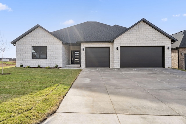 2048 N Sun Valley Dr, Springfield, MO 65802 - view of front of home featuring an attached garage, brick siding, driveway, and a front yard