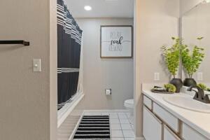151 Highland Dr Unit 3, Branson, MO 65616 - bathroom featuring vanity, a shower with shower curtain, toilet, tile patterned floors, and baseboards